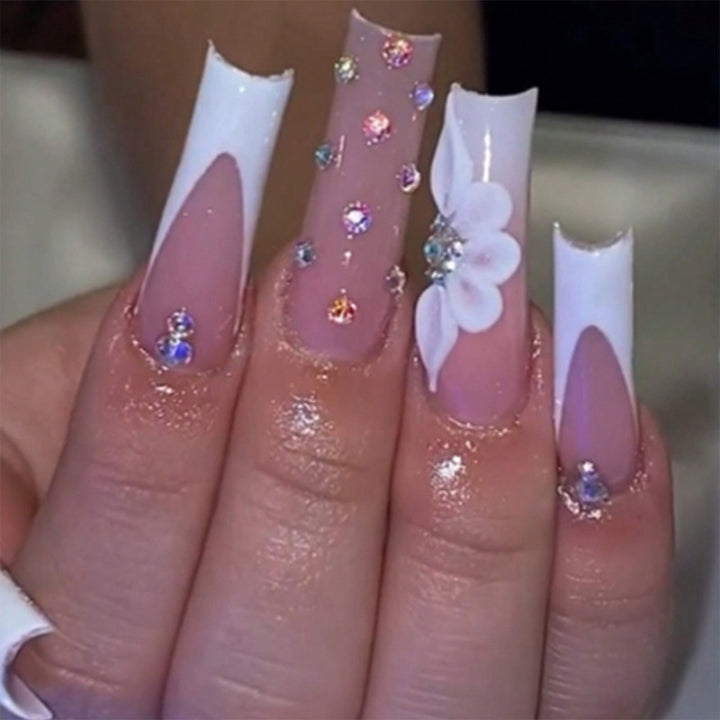 Artful stiletto nails with floral accents and rhinestone details Stornfield