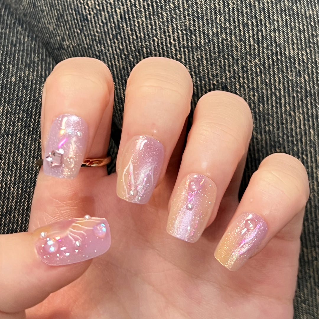 Artificial nail art with sparkling accents and transparent color gradient Stornfield