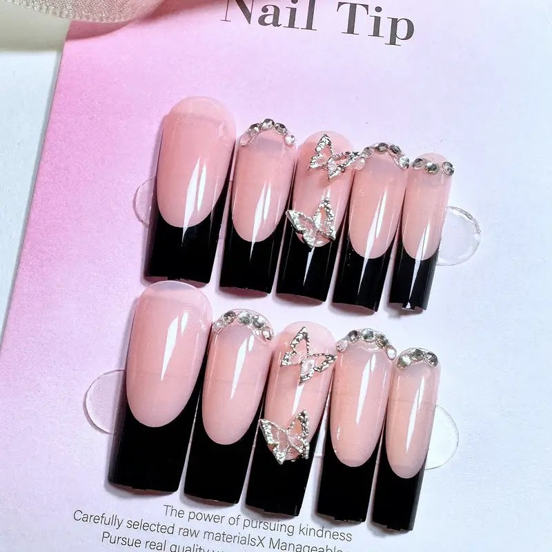 Trendy artificial nails with delicate rhinestone and butterfly accents Stornfield