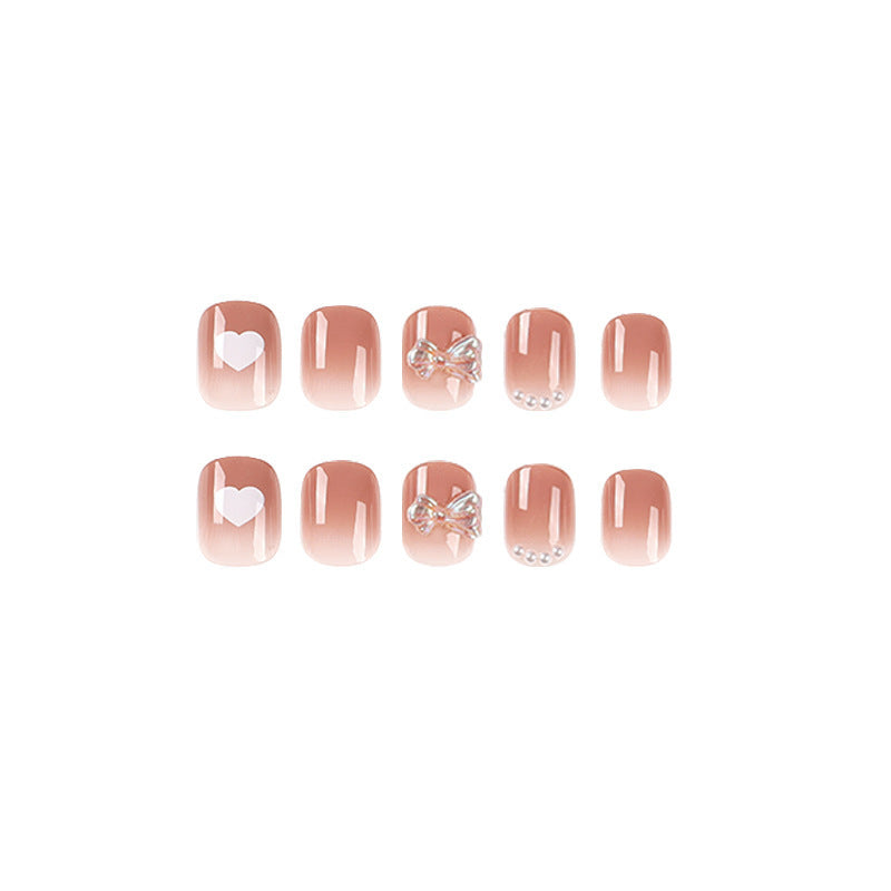 Artificial nails with romantic hearts and glitter accents Stornfield
