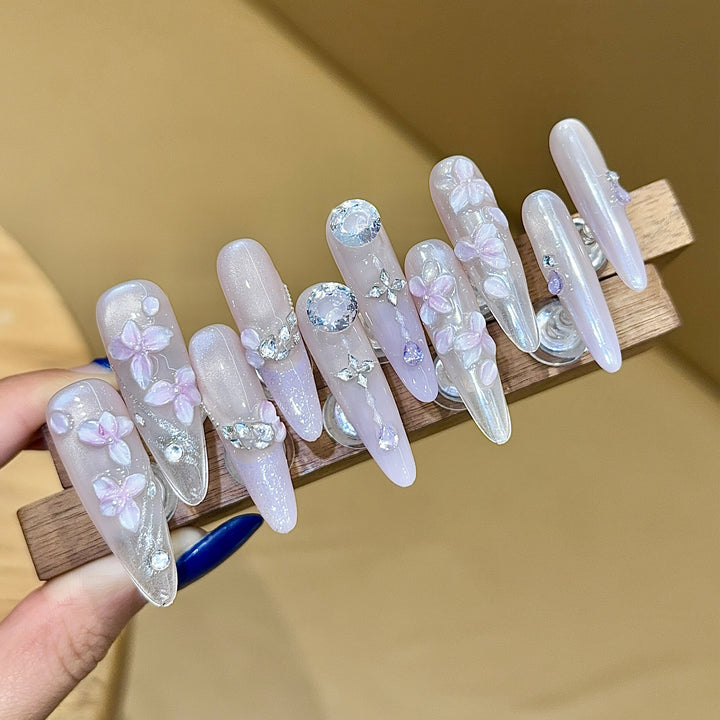 Artificial nails with delicate flower design and glitter accents Stornfield