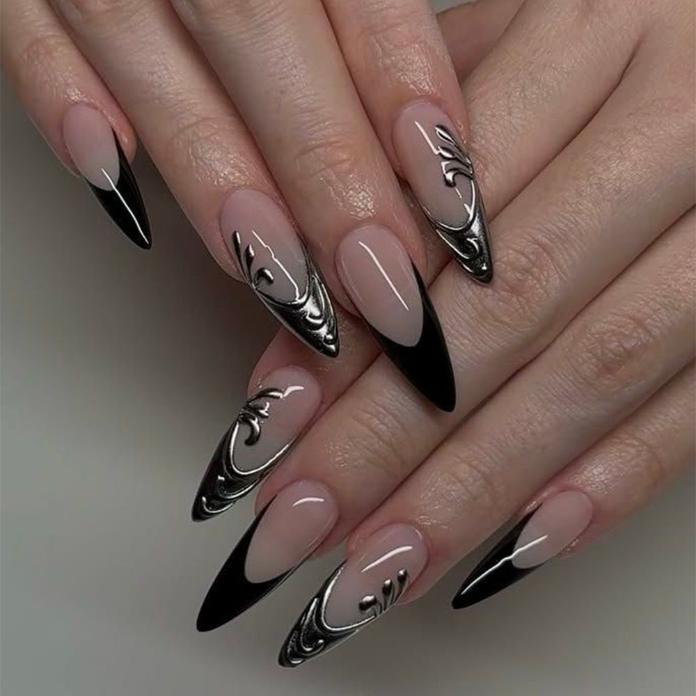 Artificial nails in elegant stiletto style with elaborate metal decoration Stornfield