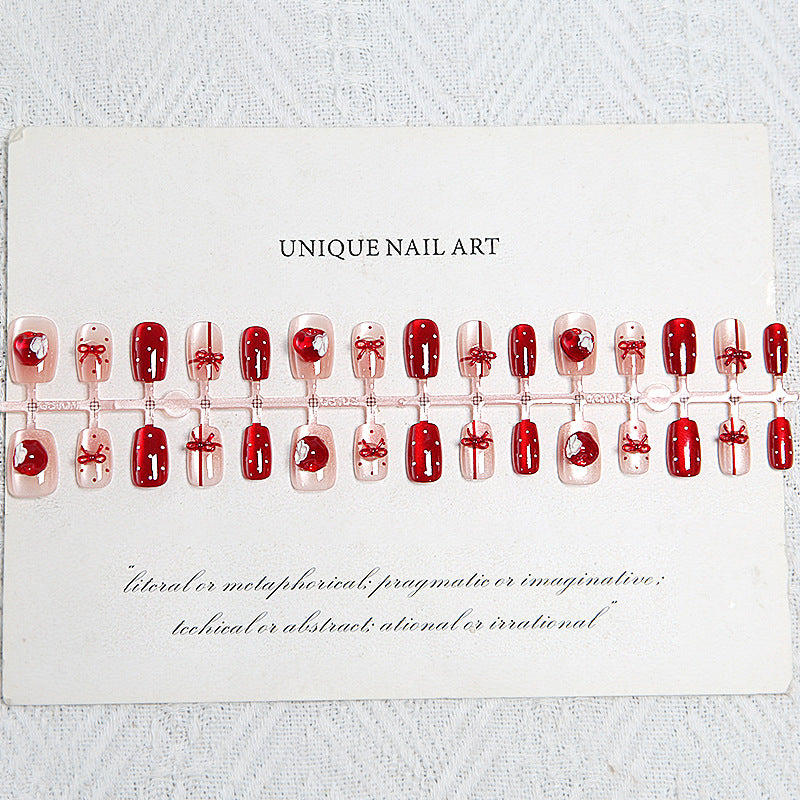 Artificial nail set with festive gift design and elegant glitter accents Stornfield
