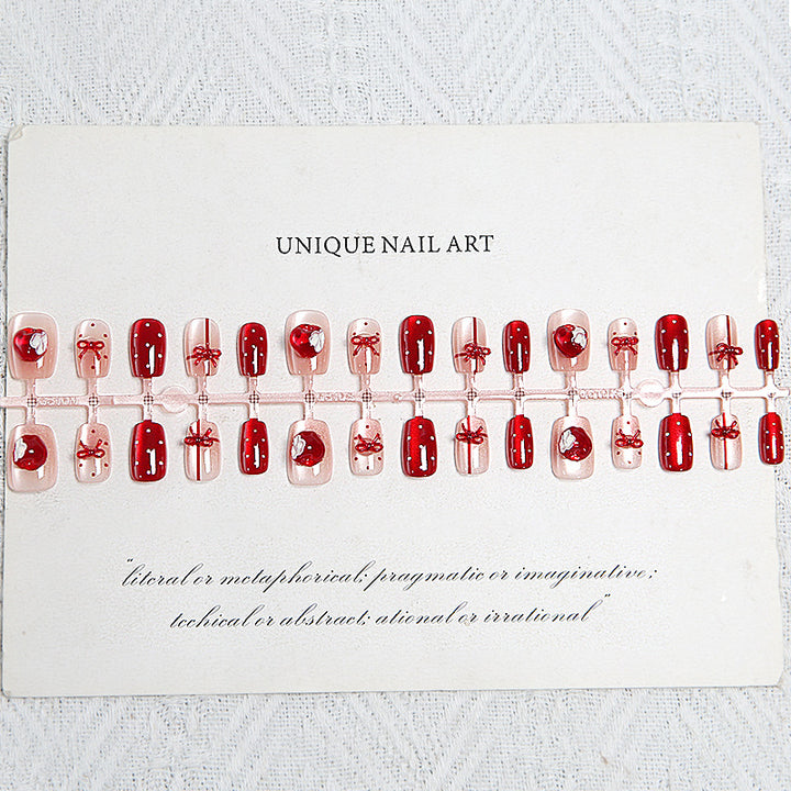 Artificial nail set with festive gift design and elegant glitter accents Stornfield