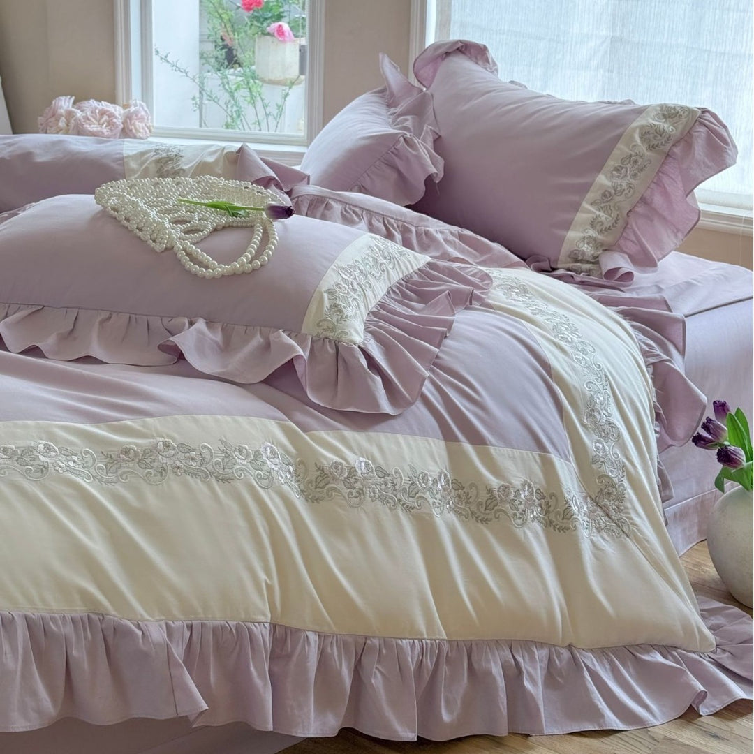 Designer bed linen set with ruffle hem and fine border embroidery