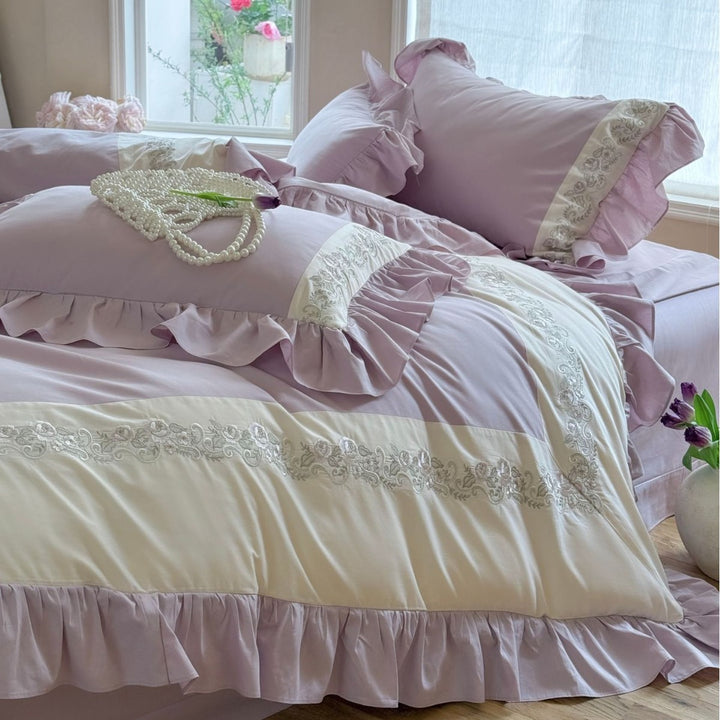 Designer bed linen set with ruffle hem and fine border embroidery
