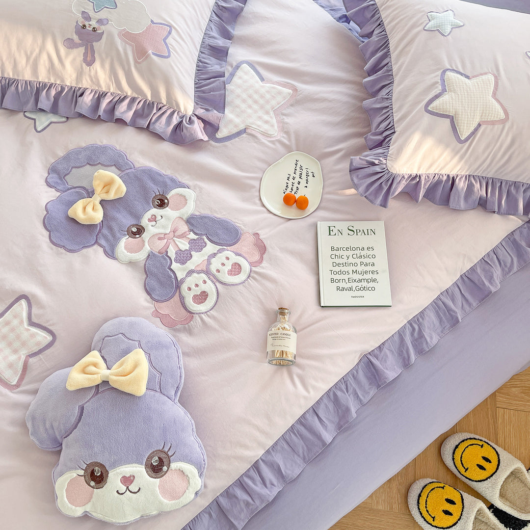 Children's bedding set with plush appliqués, ruffled flounces, and embroidery