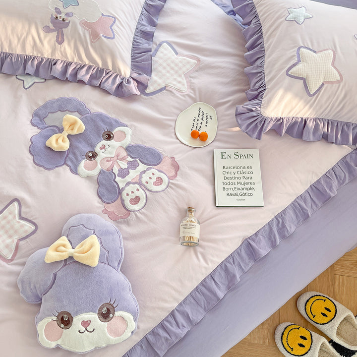 Children's bedding set with plush appliqués, ruffled flounces, and embroidery