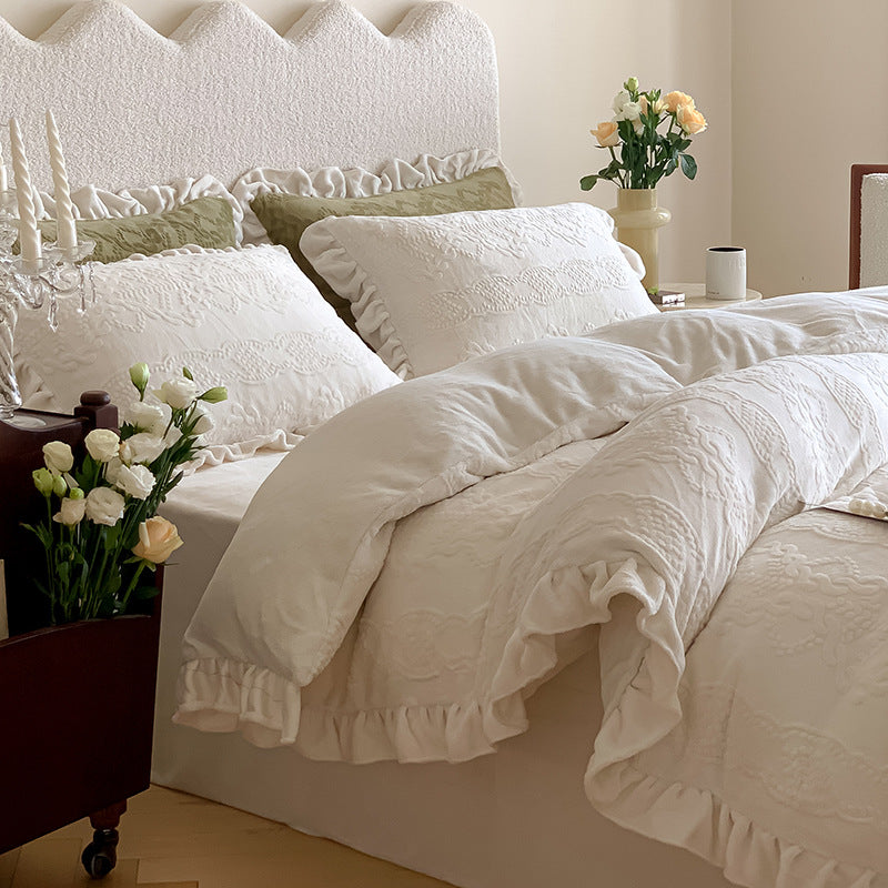 Quilted bedding set with ruffled hem and tone-on-tone embroidery