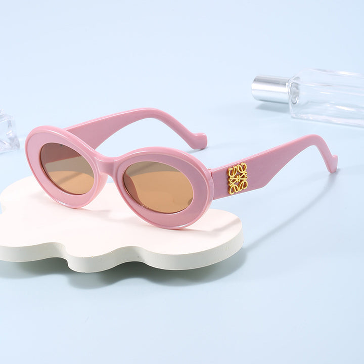 Women's fashionable sunglasses with oval frame and golden applications Stornfield