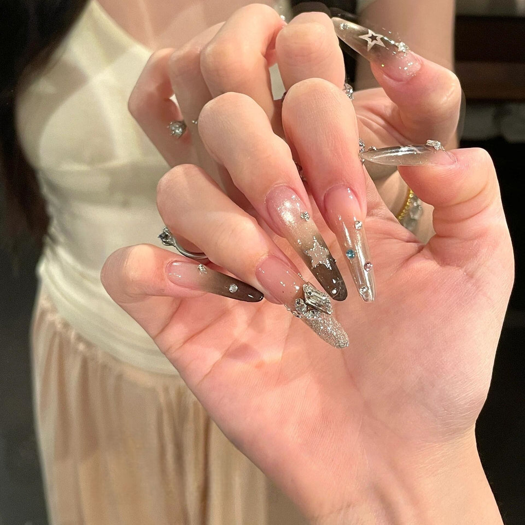 Glamorous artificial nails with sparkling rhinestone and star designs Stornfield