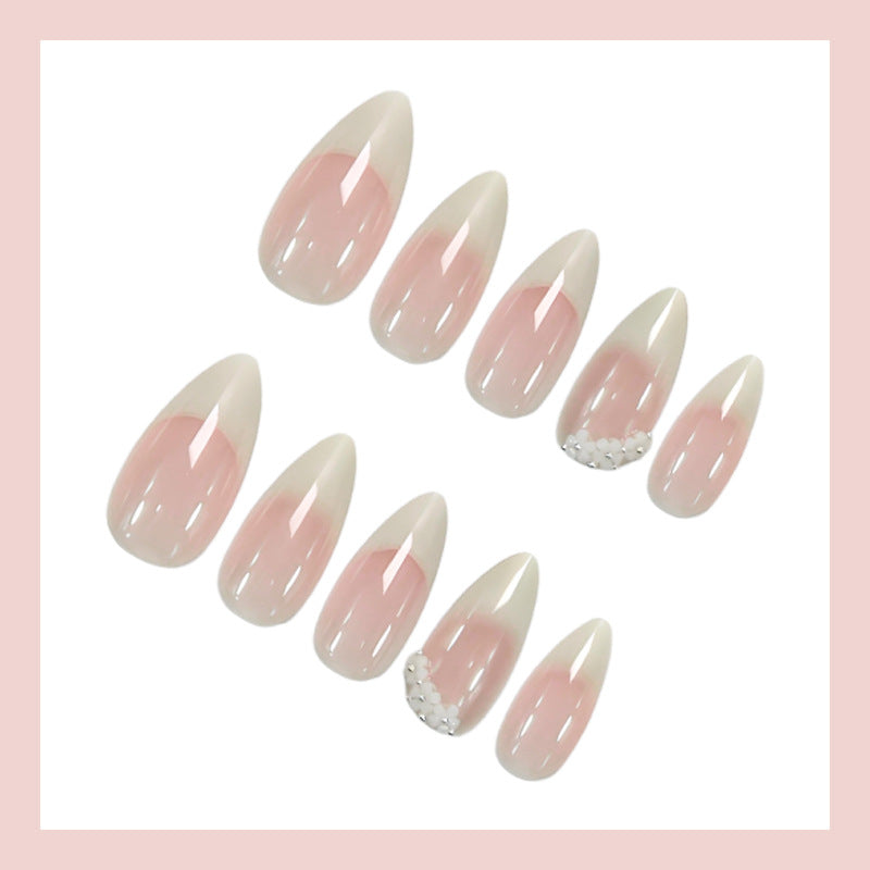 Acrylic nail set with elegant French tip and extravagant decorative details Stornfield