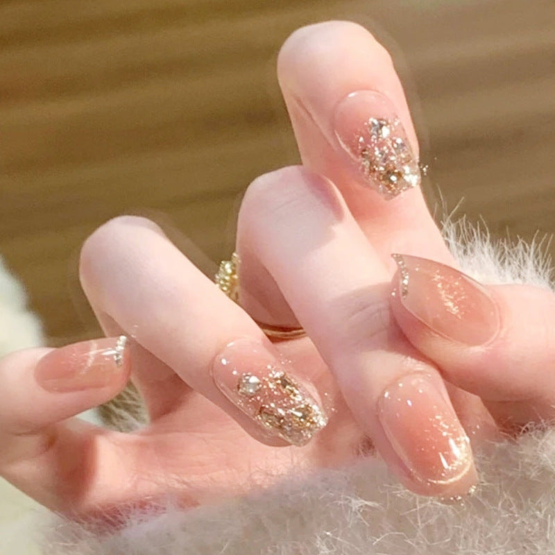 Artificial nail set with sparkling glitter and 3D applications Stornfield