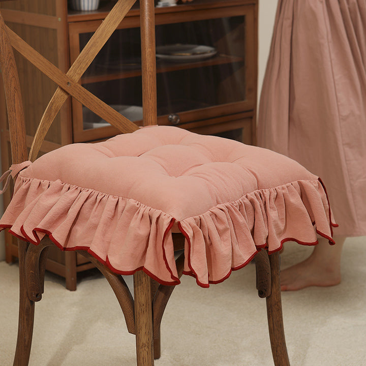 Padded chair cushion with ruffle and fastening bands