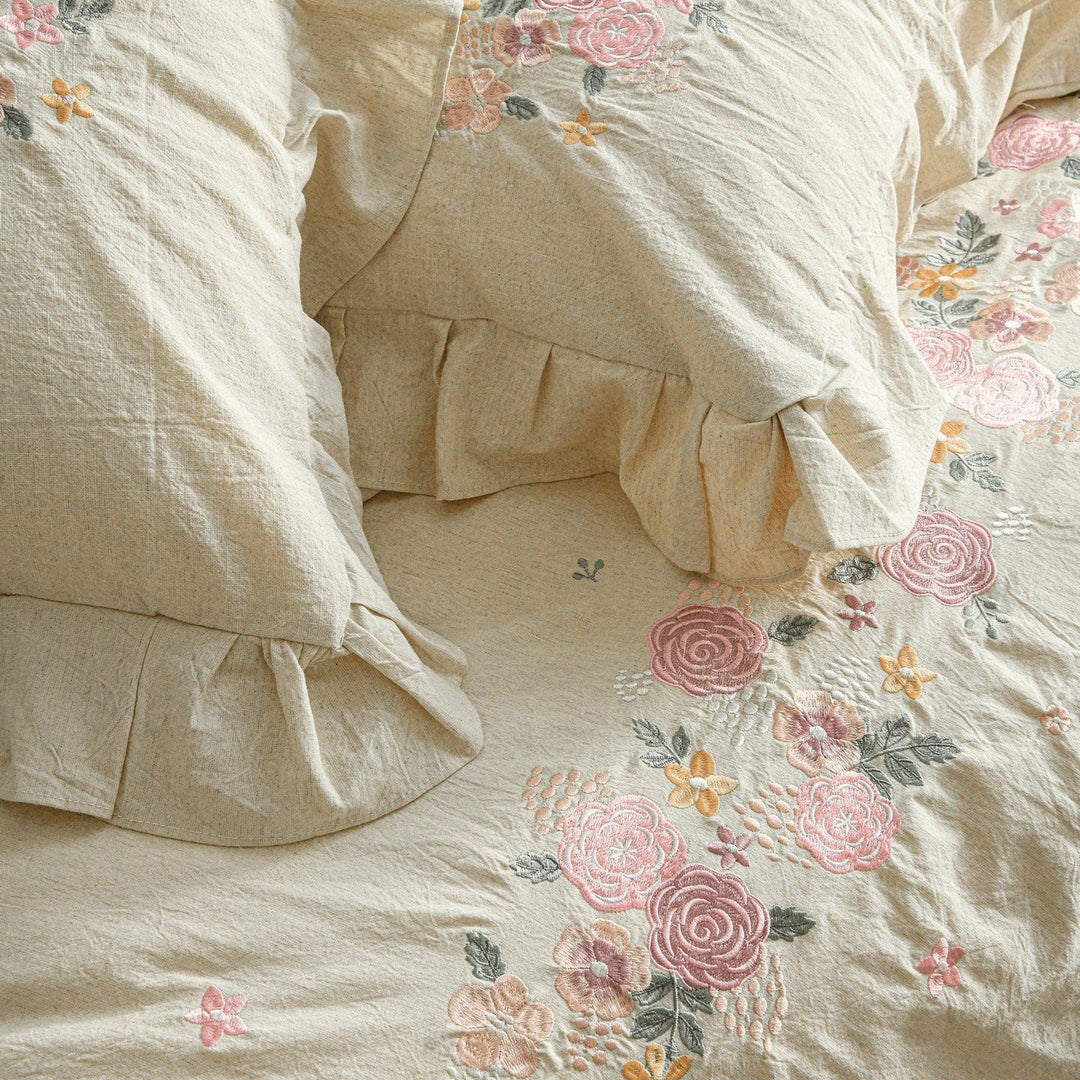 Embroidered linen-look bedding set with ruffle and floral embroidery detail