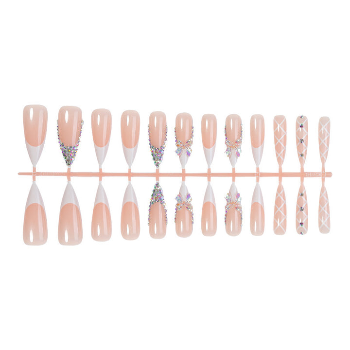 Acrylic nail set with luxurious rhinestone embellishments and bow accents Stornfield