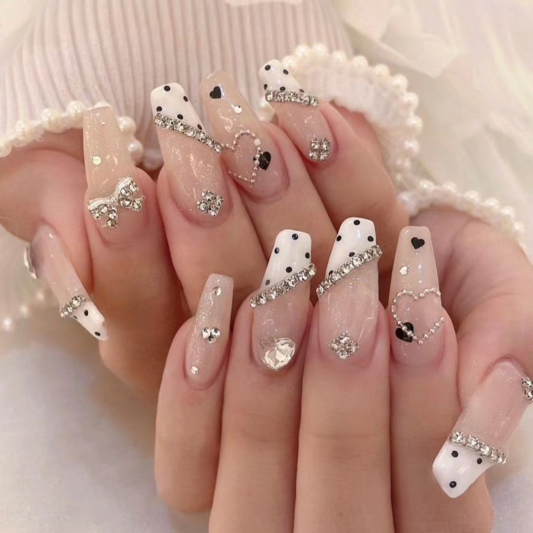 Artful nail extensions with elegant rhinestone and heart designs Stornfield