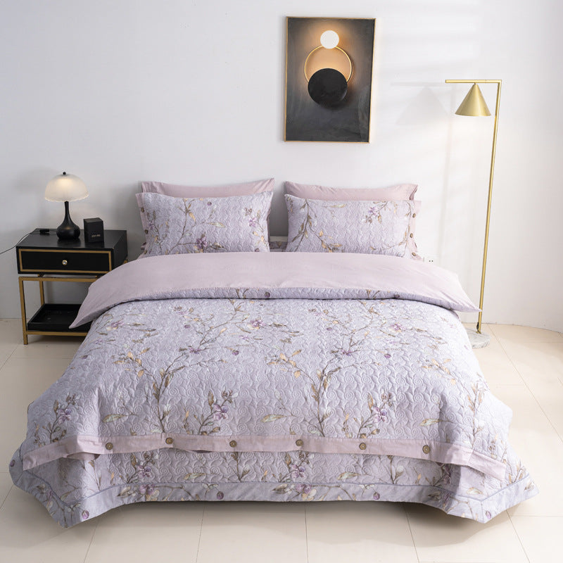 Quilted bedspread and bedding set with floral print, reversible function and decorative button placket