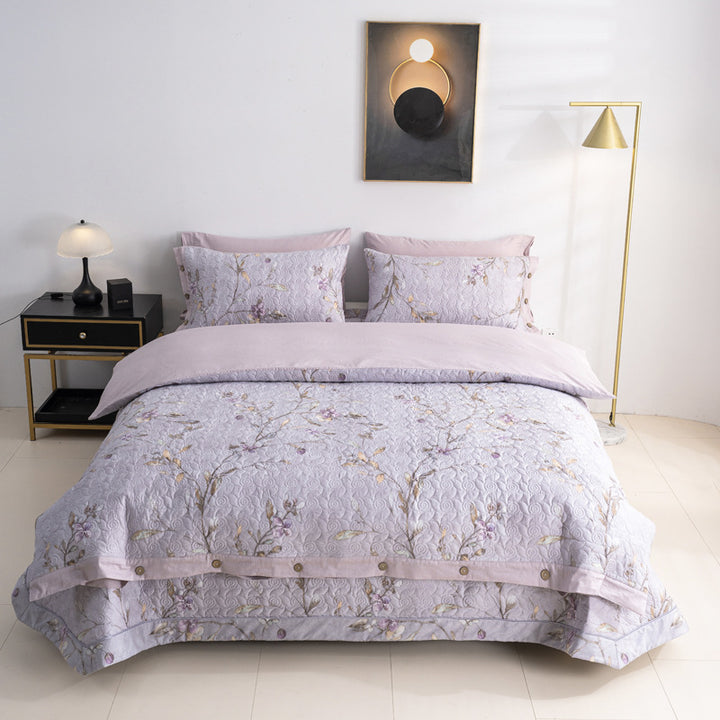 Quilted bedspread and bedding set with floral print, reversible function and decorative button placket