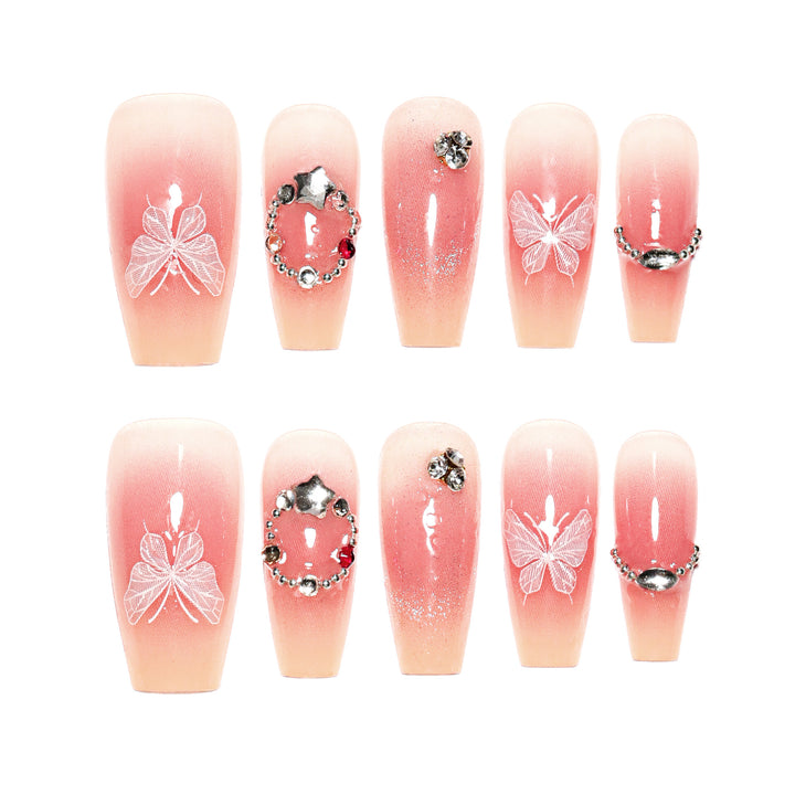 Artificial nail extensions with floral design and sparkling accents Stornfield