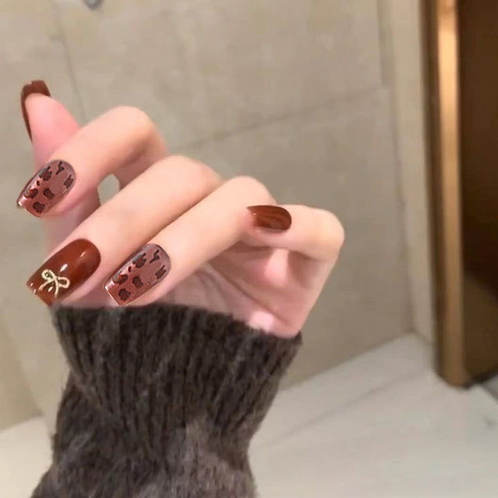 Nail set with elegant leopard pattern and luxurious accents Stornfield