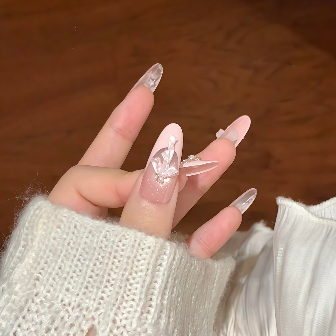 Artificial nail tips with glamorous glitter and bow details Stornfield