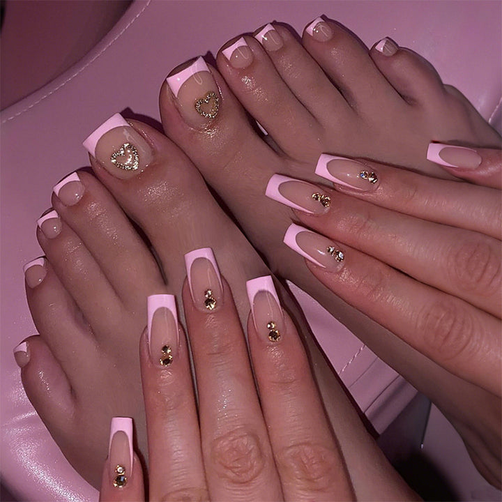 Artificial nail set with elegant French tip design and modern accents Stornfield