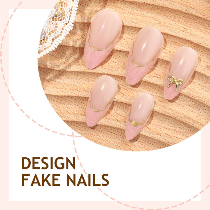 Artificial nail set with delicate bows and golden accents Stornfield