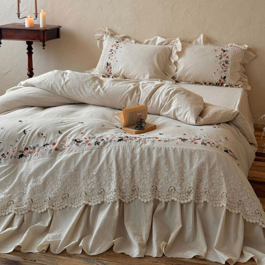 Romantic bedding set in country house style with embroidered border, frill and lace appliqué