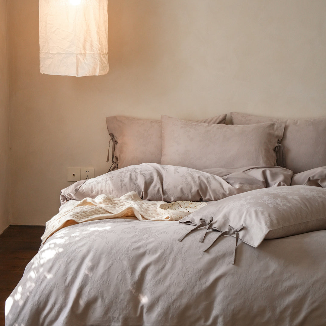 Fine cotton bedding set with jacquard floral pattern and side decorative ribbons