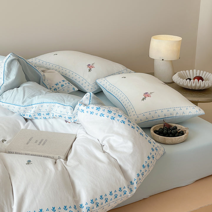 Cotton bedding set with delicate floral embroidery and decorative border