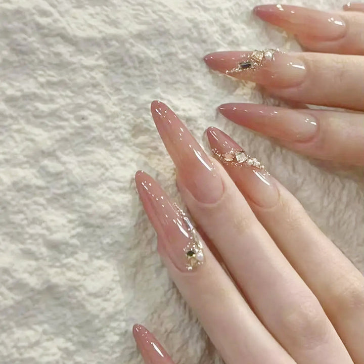 Artificial nail set with elegant ombre effect and glamorous embellishments Stornfield