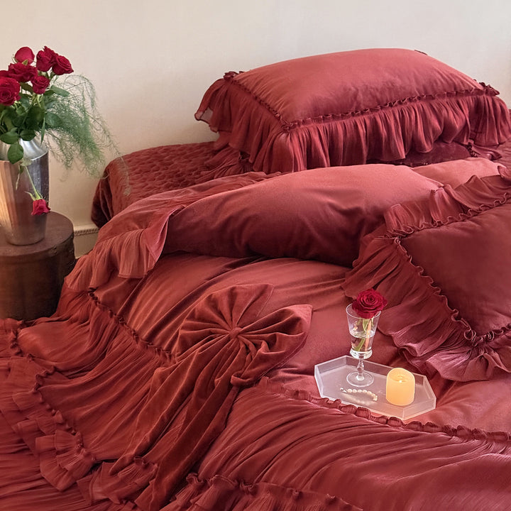 Romantic ruffled velvet bed set with pleated frills and decorative cushions