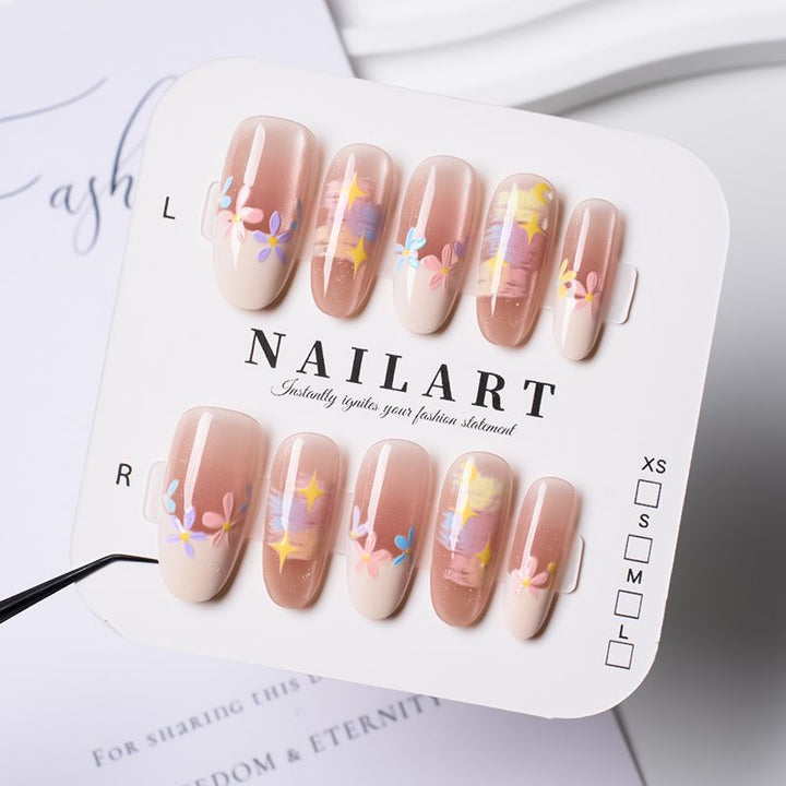 Artificial nails with delicate floral accents and glitter effects Stornfield