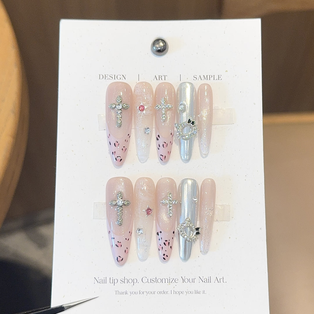 Artificial nails with sparkling rhinestones and cross motifs Stornfield