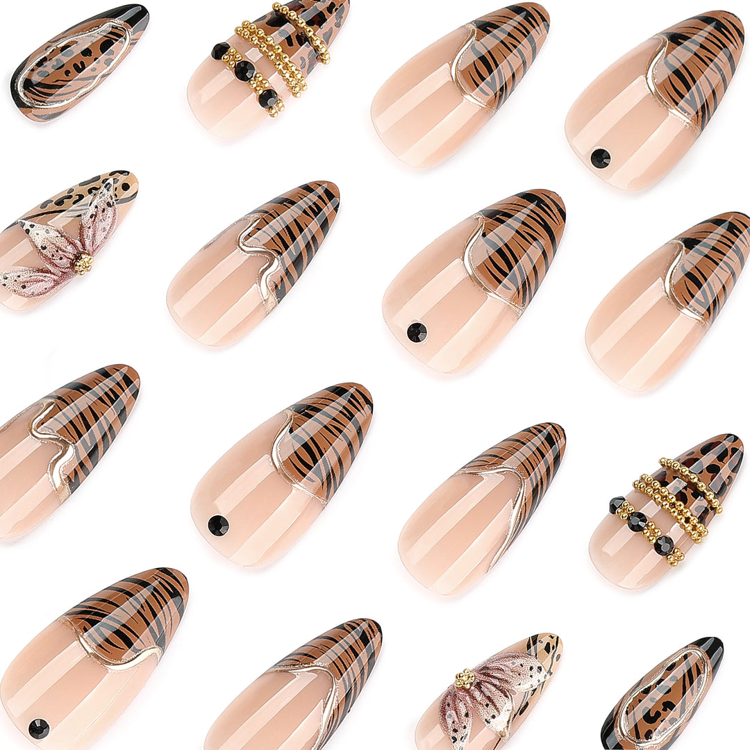 Artful stiletto nail with floral accents and gold embellishments Stornfield