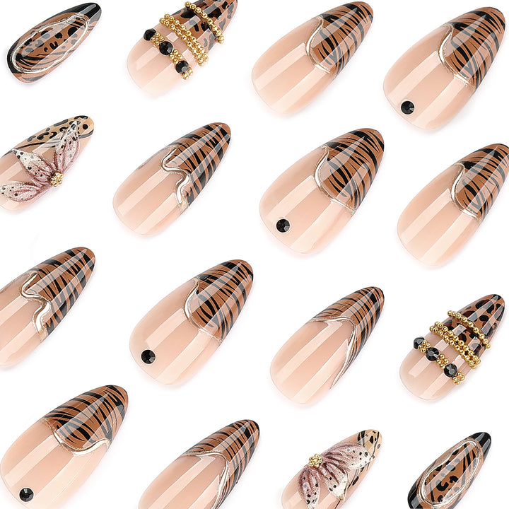 Artful stiletto nail with floral accents and gold embellishments Stornfield