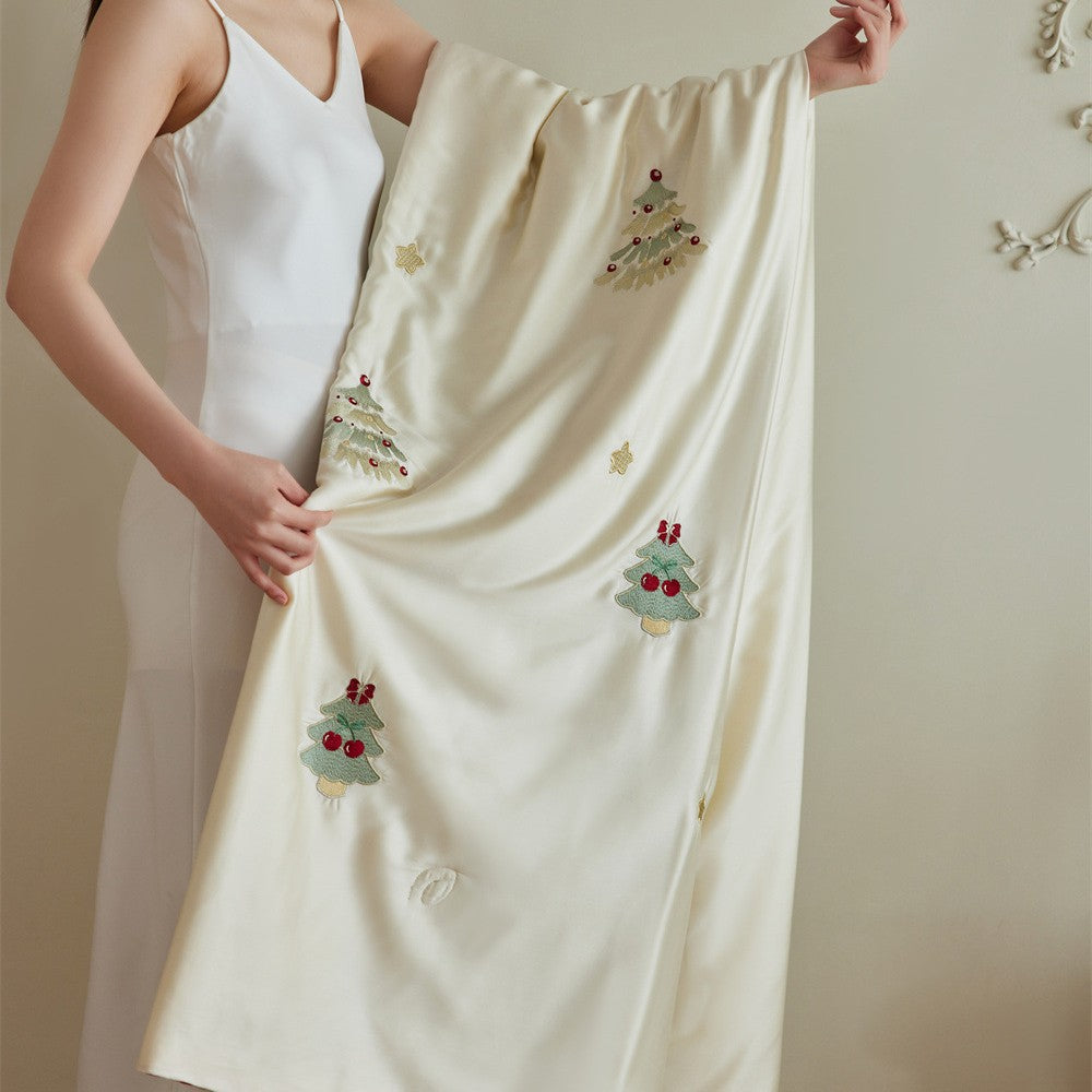 Luxurious satin bed linen set with embroidered Christmas tree motifs and contrasting piping