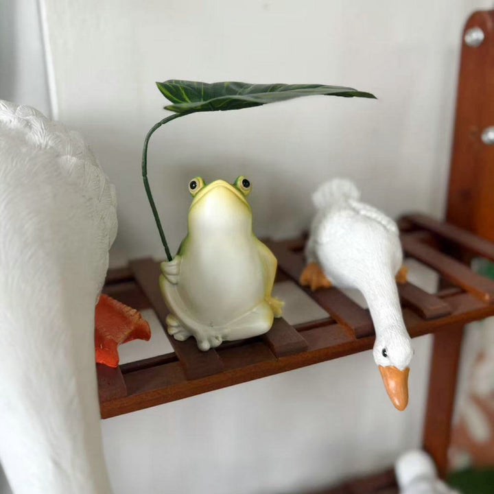 Playful frog decorative figure with leaf Stornfield