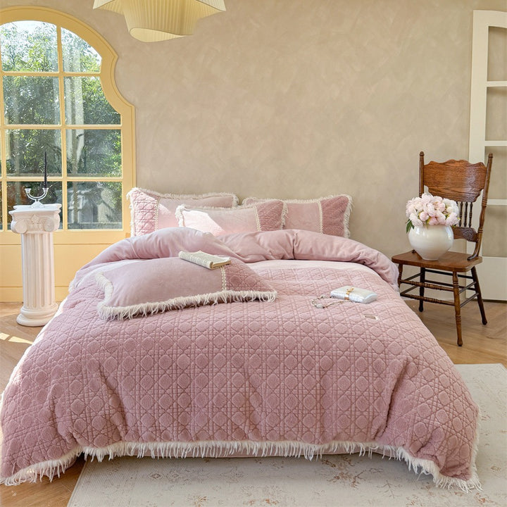 Quilted bedding with fringes and decorative pillows