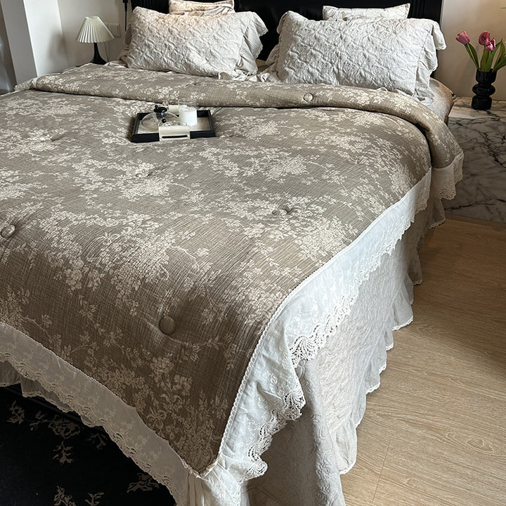 Quilted bedspread with lace trim and vintage stripe pattern