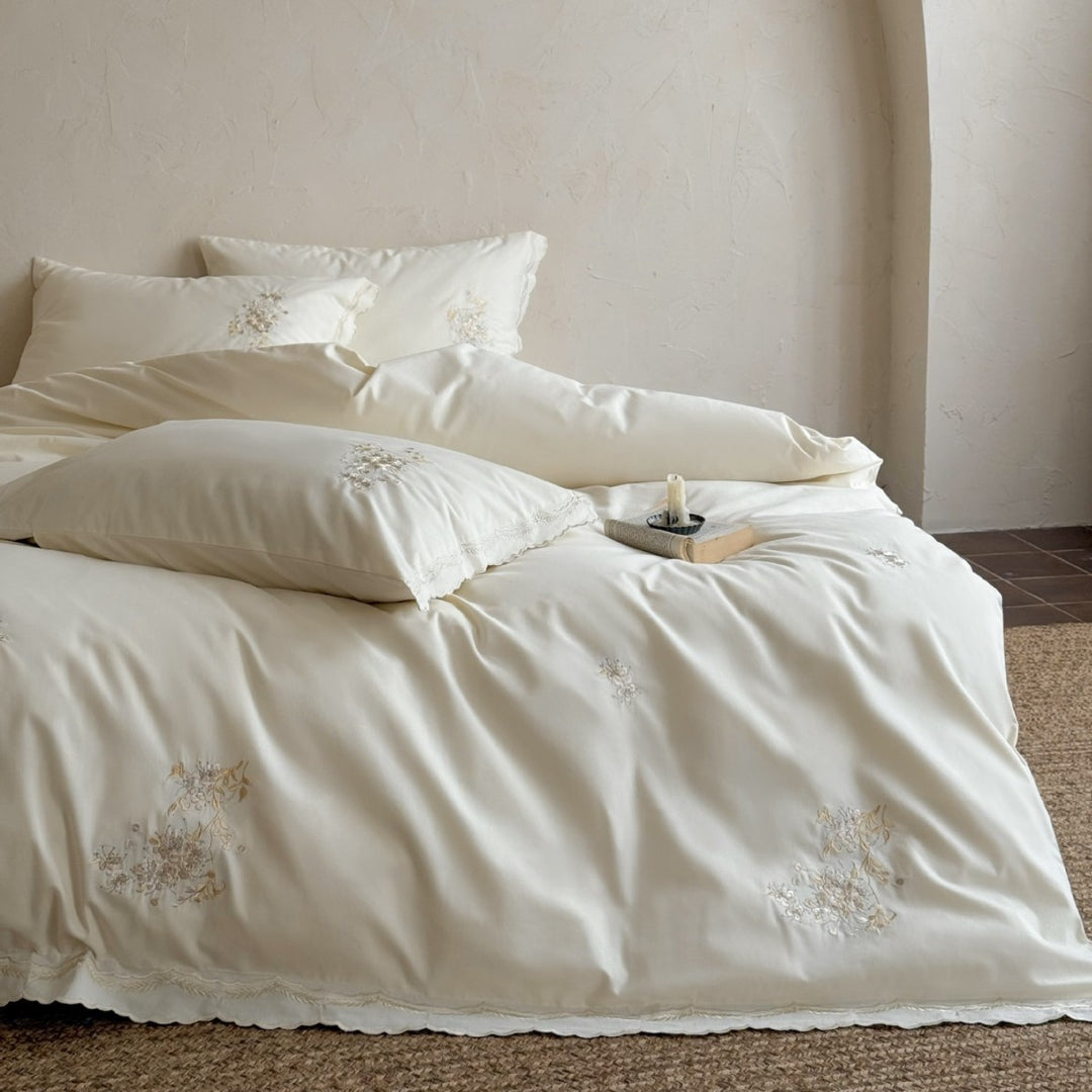 Fine cotton satin bedding set with floral relief embroidery and delicate lace edge