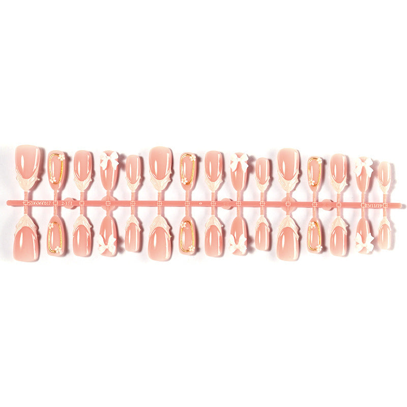 Artificial nail set with playful bow accents and delicate embellishments Stornfield