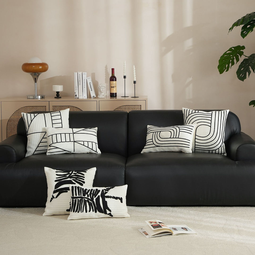 Decorative cushion cover with textured embroidery and geometric line motif