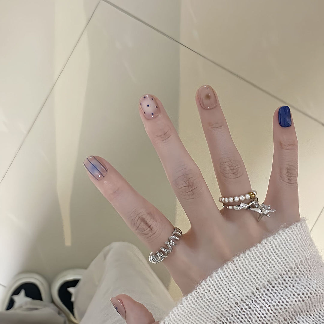 Artificial nails in modern design with geometric and sparkling accents Stornfield