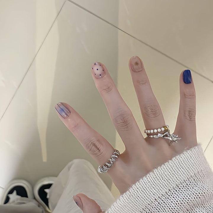 Artificial nails in modern design with geometric and sparkling accents Stornfield