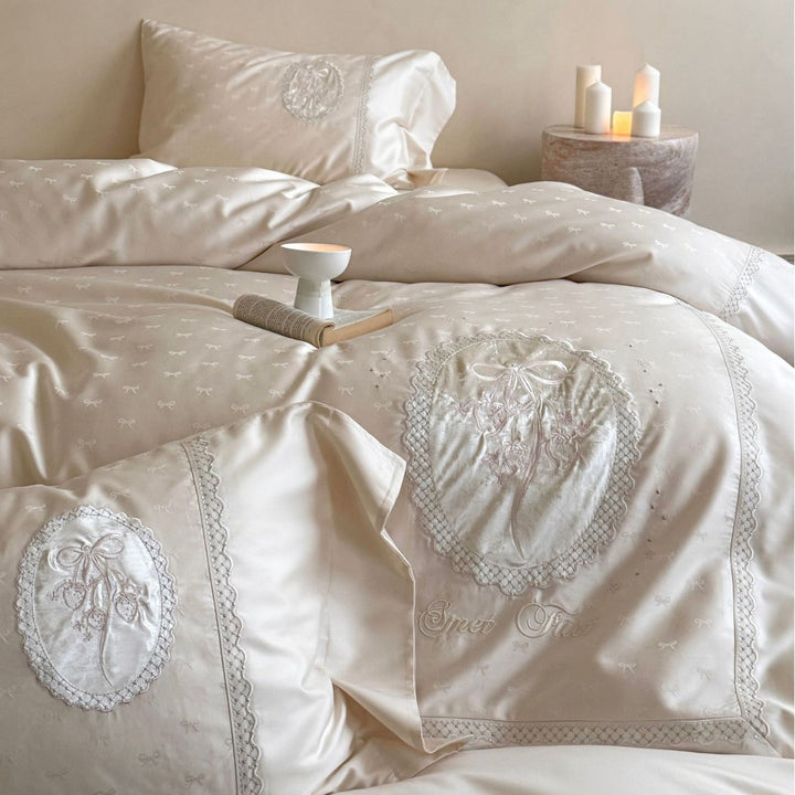 Luxurious cotton satin bedding set with embroidered medallion appliqués and lace trim