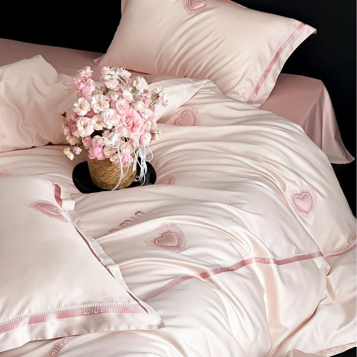 Luxurious cotton satin bedding set with heart applique and decorative piping