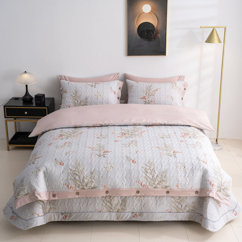 Quilted bedspread and bedding set with floral print, reversible function and decorative button placket