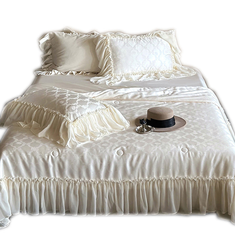 Elegant satin bed linen set with generous ruffle trim and tone-on-tone jacquard pattern